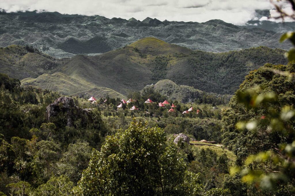 Scenic mountain range backdrop with charming resort houses nestled in the foreground, inviting relaxation and adventure.