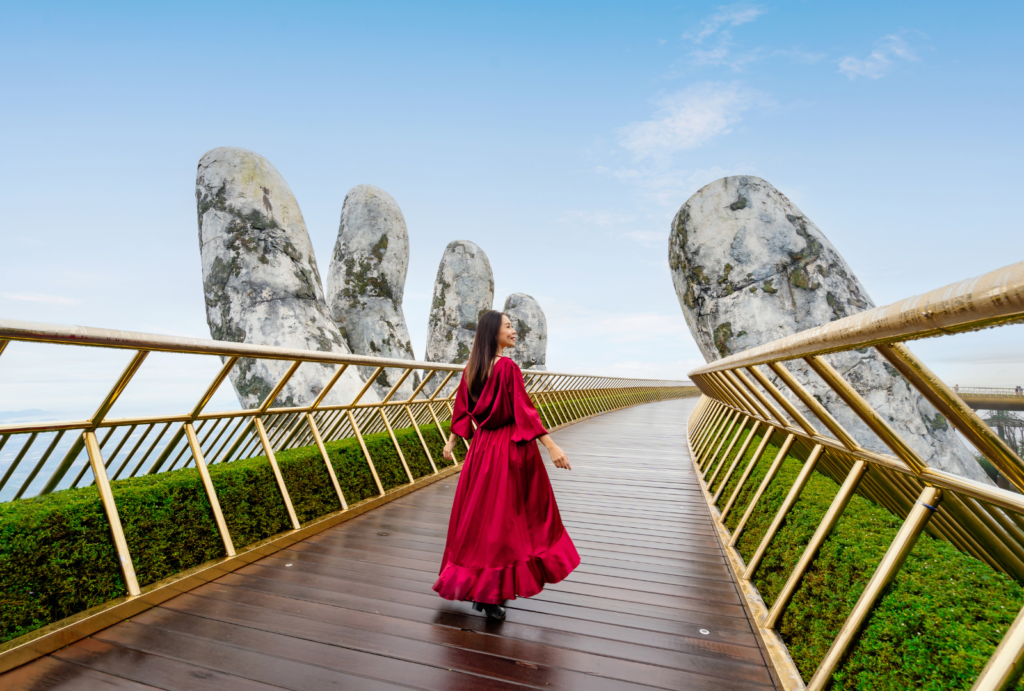 Young woman traveler at Golden Bridge in Bana hills, Danang Vietnam