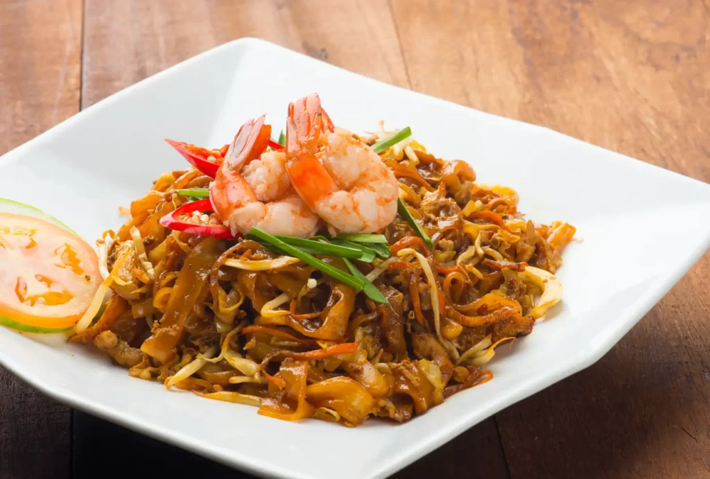 A vibrant plate of Char Kway Teow featuring succulent shrimp and colorful vegetables, ready to delight your taste buds.
