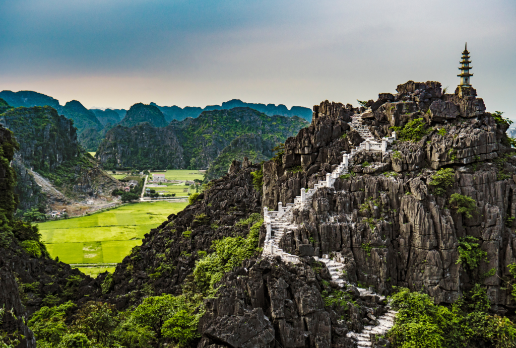 Ninh Binh is a serene and scenic destination in northern Vietnam, where towering limestone karsts rise dramatically from rice fields and rivers.