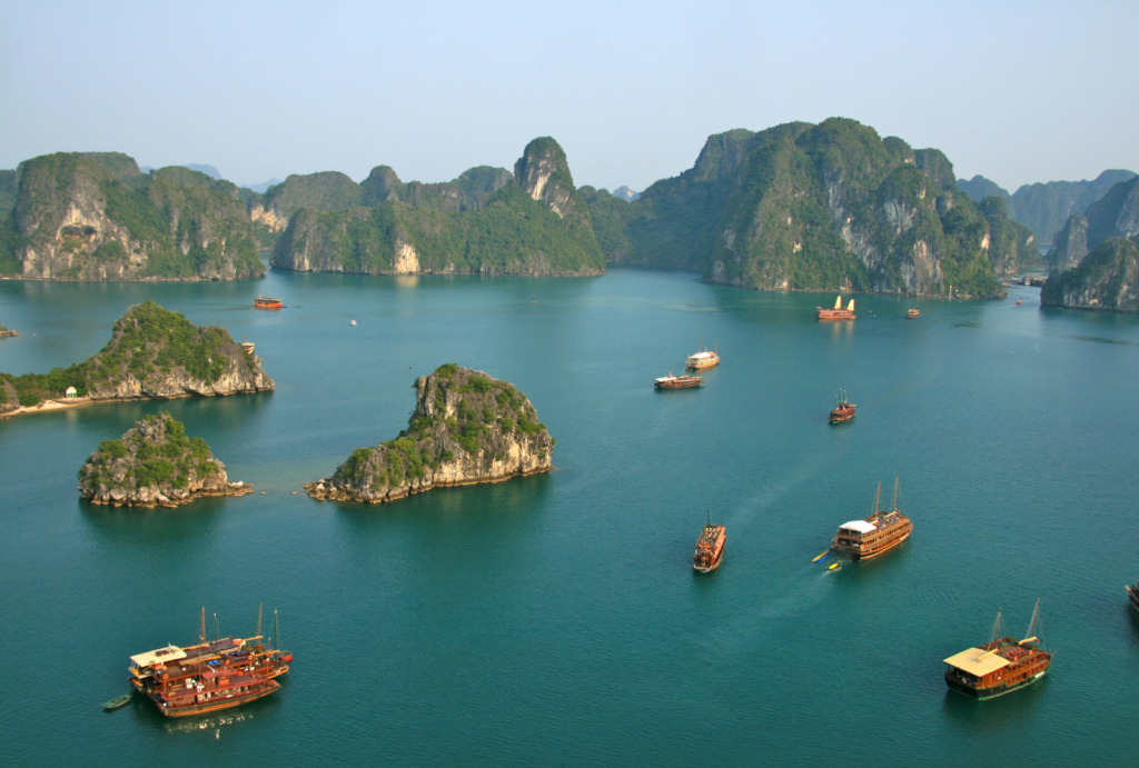 Halong Bay is known for its emerald waters and towering limestone islands. Designated as a UNESCO World Heritage Site, the bay is dotted with over 1,600 islands and islets, creating a surreal seascape. Visitors can take luxury cruises to explore hidden caves, floating villages, and secluded beaches