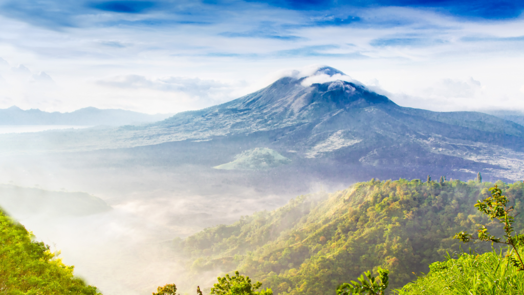 "Breathtaking view of Mount Batur, an active volcano in Bali, Indonesia. A popular sunrise trekking destination offering panoramic views over Bali’s lush landscape."