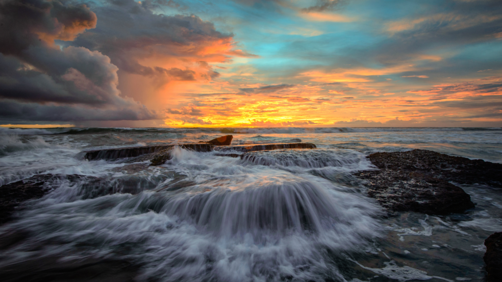 "Scenic view of Lima Beach in Canggu, Bali, with golden sands, gentle waves, and beachside lounges perfect for relaxation. A popular spot for beachgoers and surfers in Bali."