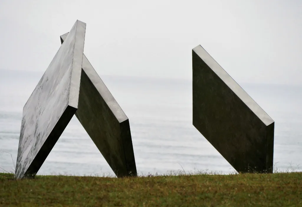 Abstract contemporary sculpture against a moody seascape on Naoshima Art Island, a highlight of luxury Japan travel and exclusive Japan art tours for connoisseurs of modern design.