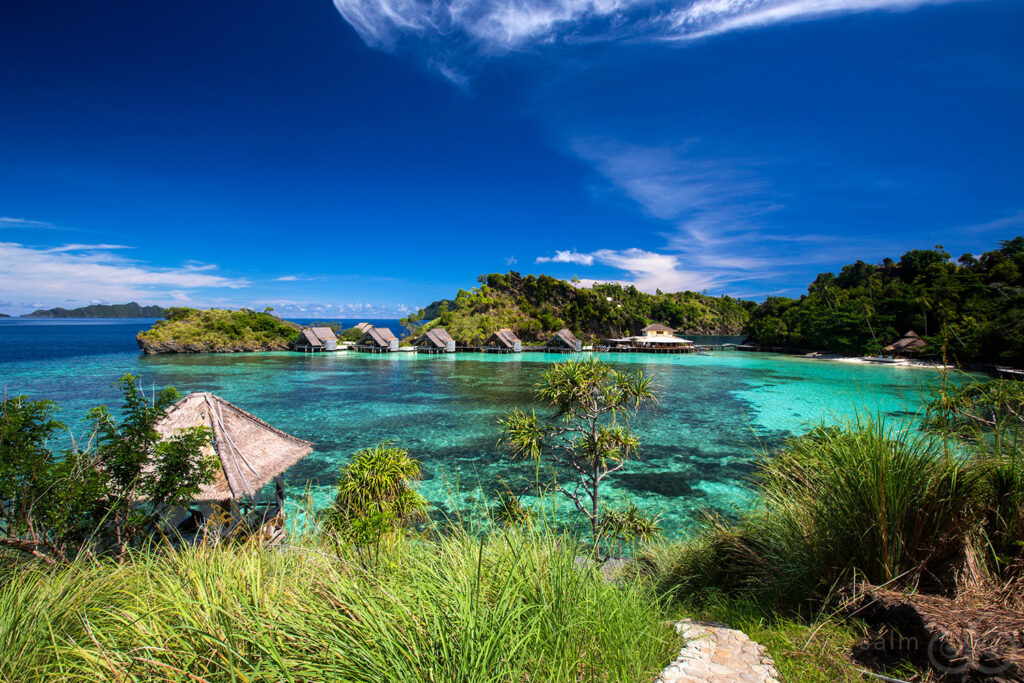 A stunning beach scene featuring a cozy hut and a picturesque island