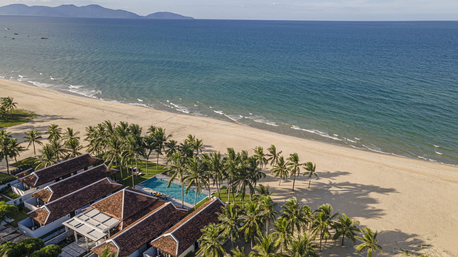 Four Seasons Resort The Nam Hai: A luxurious beachfront property with spacious villas, kids' activities, and a serene atmosphere.