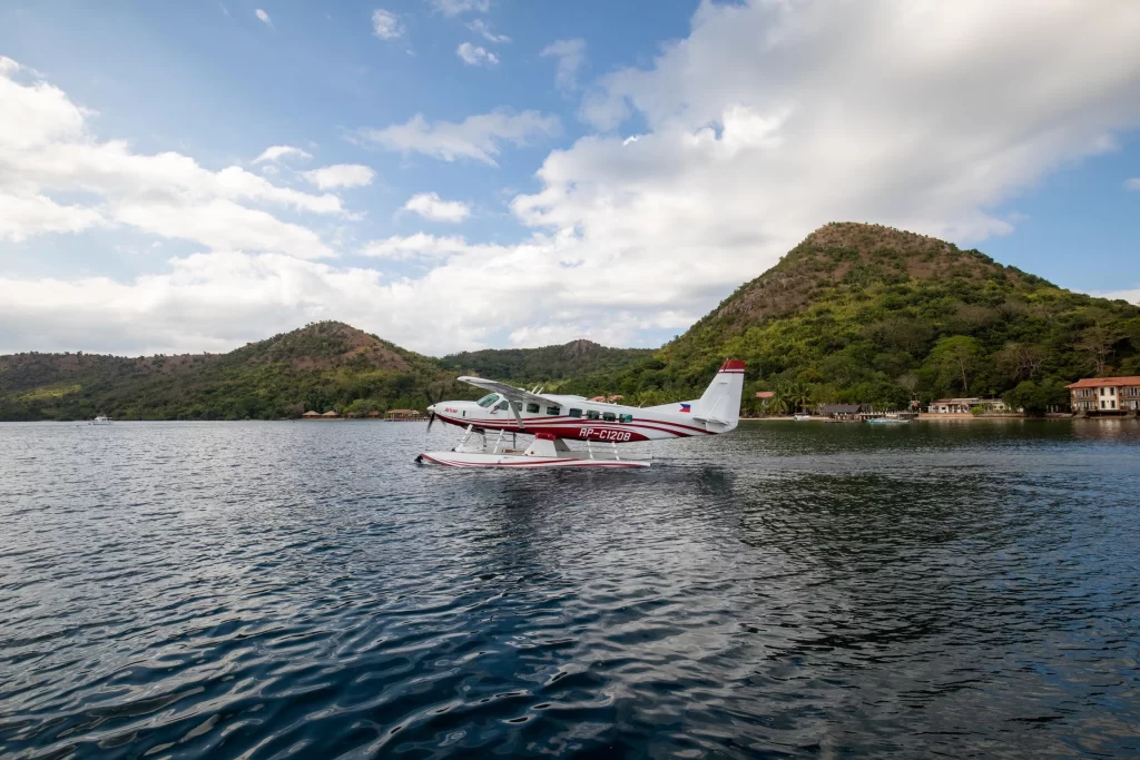 A small seaplane soars above the sparkling waters during an air safari in the stunning Philippines.