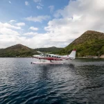 A small seaplane soars above the sparkling waters during an air safari in the stunning Philippines.