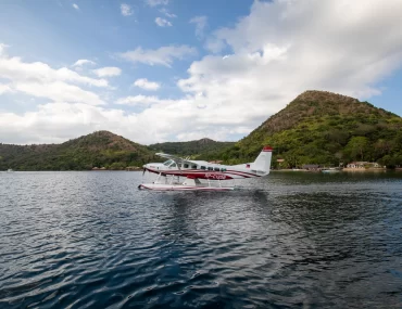 A small seaplane soars above the sparkling waters during an air safari in the stunning Philippines.