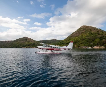 A small seaplane soars above the sparkling waters during an air safari in the stunning Philippines.