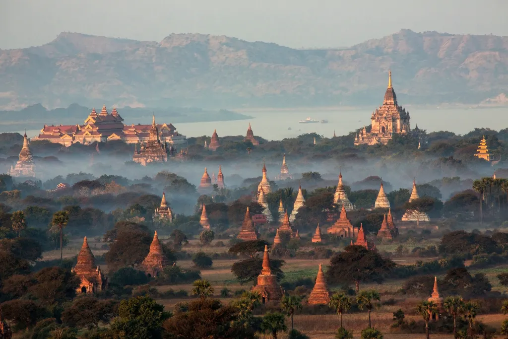 Bagan temples rising from the morning mist beside the Irrawaddy River, Myanmar