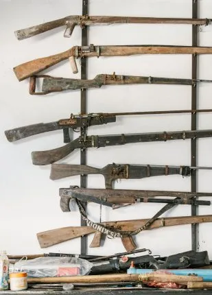 Detailed view of confiscated poaching rifles, illustrating the vital anti-poaching initiatives that high-end travelers support when booking with a conservation-focused Cambodia DMC.