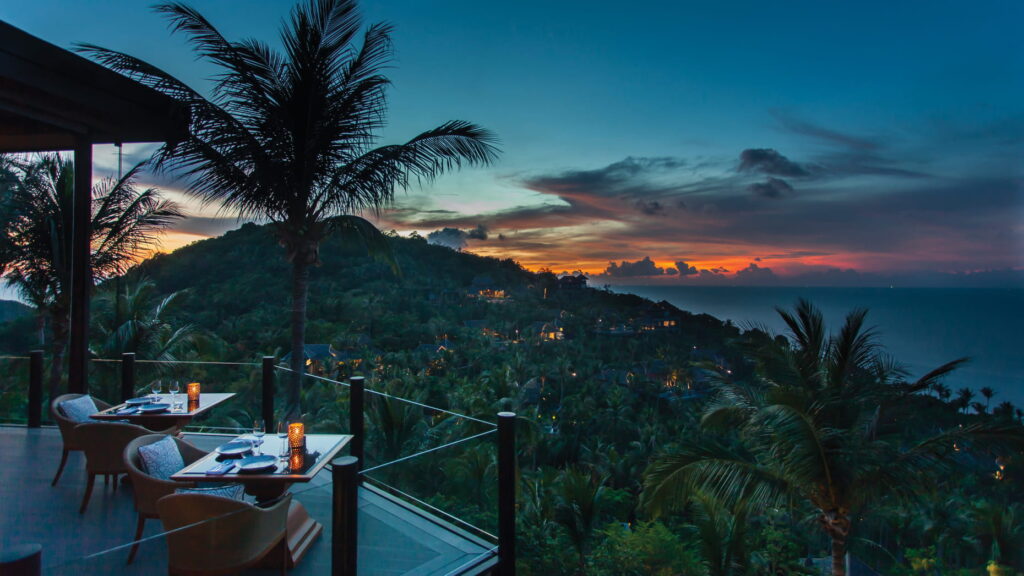 Breathtaking sunset view from the resort's peak, casting vibrant colors over the horizon and surrounding landscape.