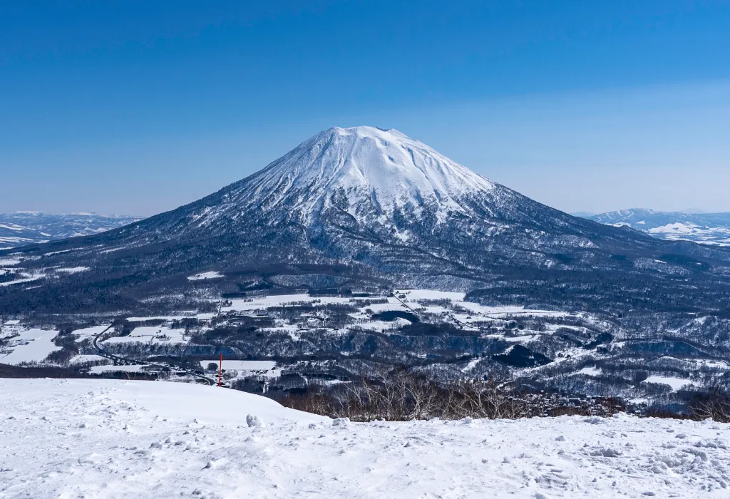 Panoramic view of snow-covered Mount Yōtei (Ezo Fuji) near Niseko, Japan. Book exclusive winter Japan tours and ski Japan holidays with our luxury Japan travel services.