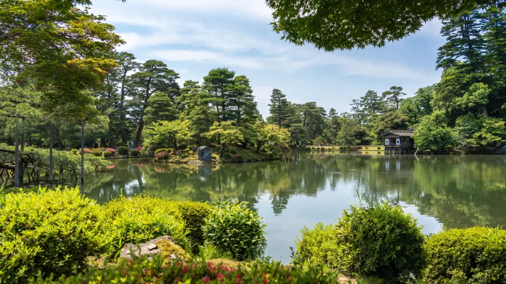 The still central pond of Kenroku-en in spring, Kanazawa — one of Japan's three great gardens and the centrepiece of a city that rivals Kyoto for heritage without the crowds