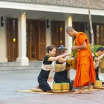 Buddhist monks receiving morning alms outside a luxury hotel in Luang Prabang, a signature cultural experience