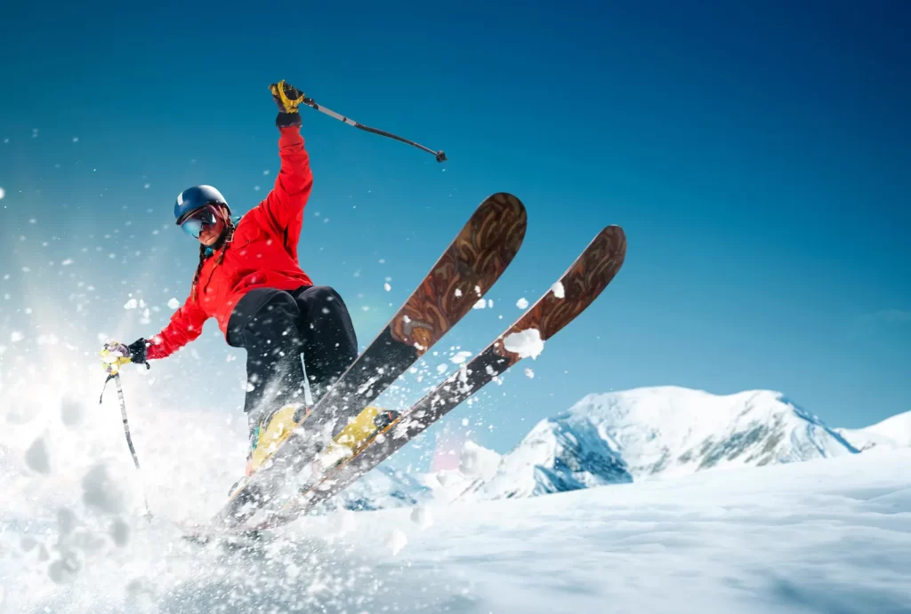 Skier in high-end gear enjoying fresh powder, showcasing a thrilling and luxurious skiing experience.