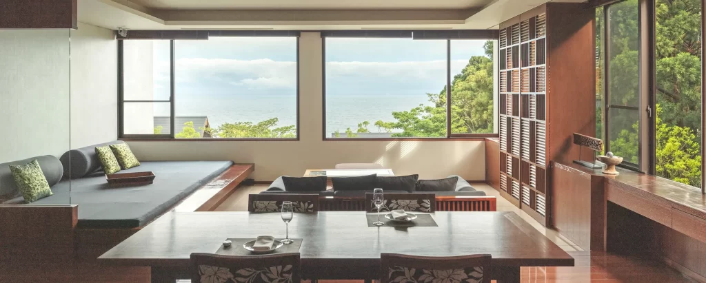 The luxurious interior of Sankara Hotel & Spa Yakushima, featuring a modern dining area, comfortable lounge seating, and large windows with an ocean view. Premium accommodation for Japan tours and bespoke Japan DMC itineraries.