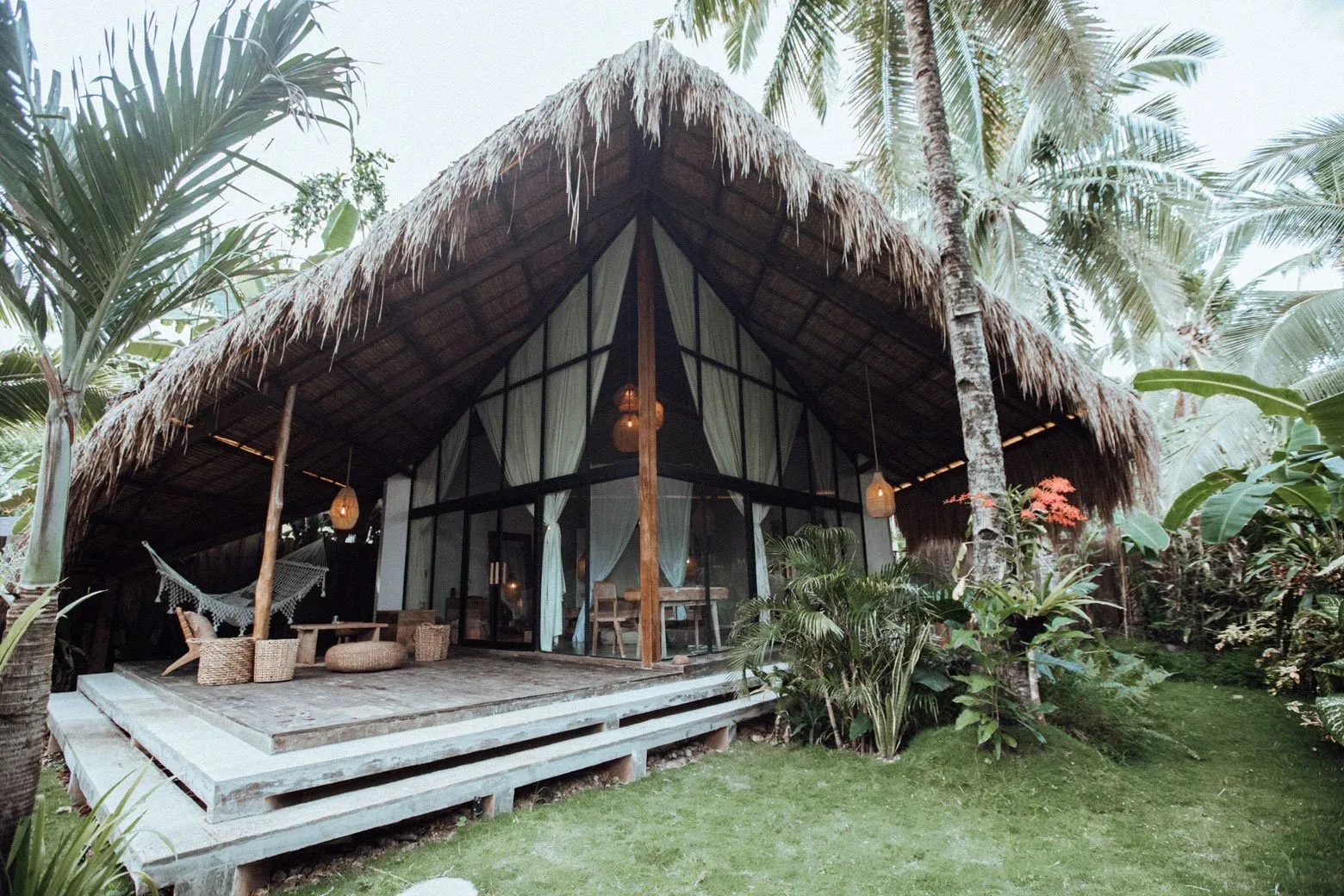 Thatched-roof villa exterior at Bombora Siargao, a jungle hideaway near Santa Fe, Siargao.
