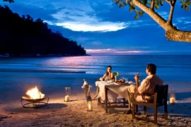Romantic luxury beach holiday dinner in Malaysia for couples, ideal for a romantic travel getaway planned by a Malaysia DMC.