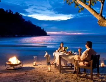 Romantic luxury beach holiday dinner in Malaysia for couples, ideal for a romantic travel getaway planned by a Malaysia DMC.