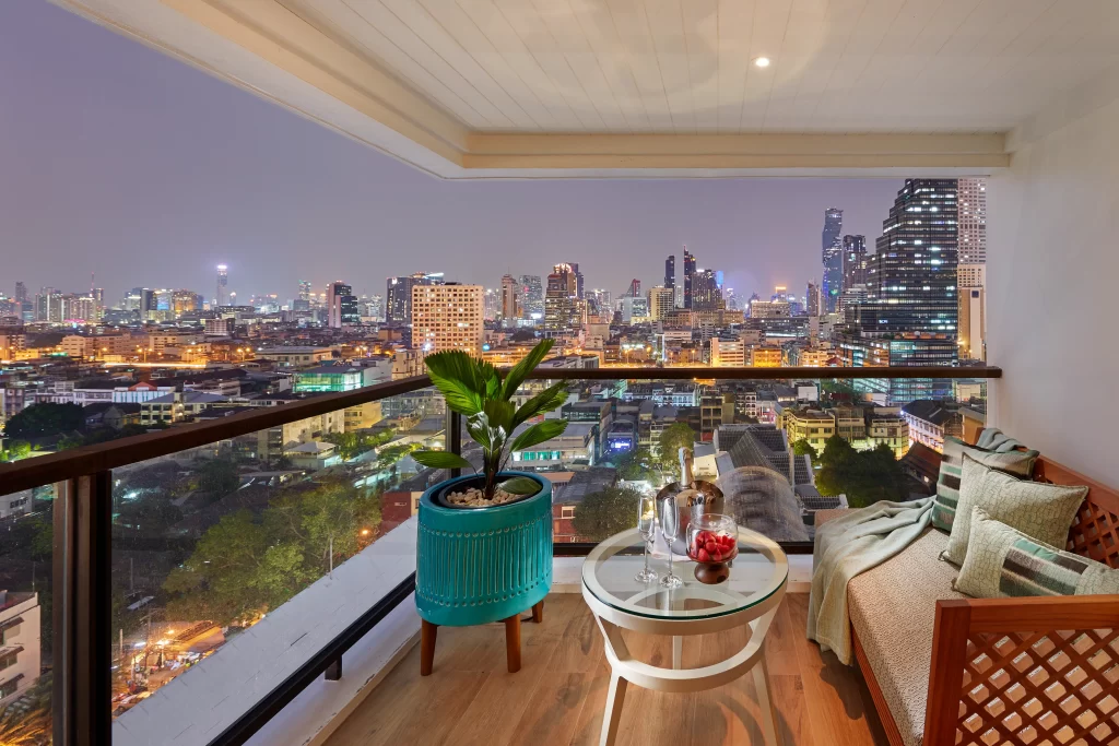 Private balcony at the Mandarin Oriental Bangkok with champagne, city skyline views at night, and the glittering lights of Bangkok below — luxury hotel in the heart of the Thai capital