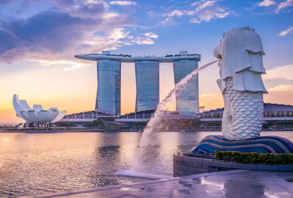 Majestic Singapore Merlion statue silhouetted against a vibrant sunset, showcasing the city's iconic landmark in stunning colors.