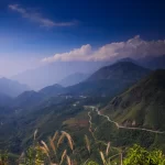 Winding mountain pass through forested peaks in northern Vietnam