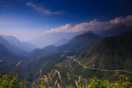 Winding mountain pass through forested peaks in northern Vietnam