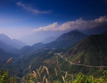 Winding mountain pass through forested peaks in northern Vietnam