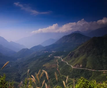 Winding mountain pass through forested peaks in northern Vietnam