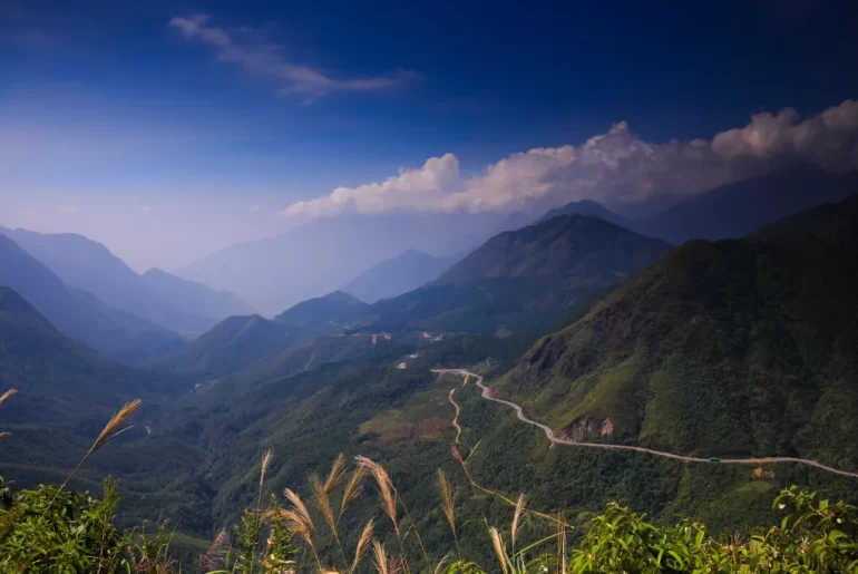 Winding mountain pass through forested peaks in northern Vietnam