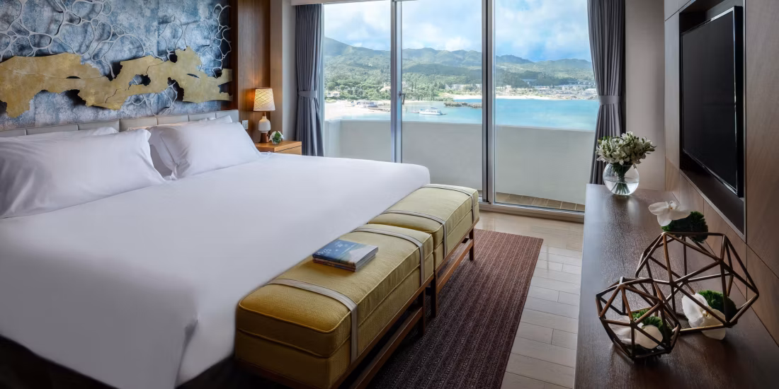 A modern, bright hotel room overlooking the beach and turquoise ocean at the InterContinental ANA Okinawa. The ultimate beachside accommodation for luxury Japan tours and holidays.