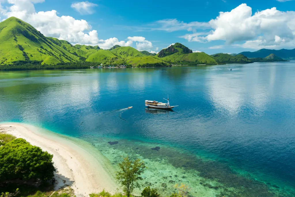 Phinisi anchored in a turquoise bay, Komodo National Park, Indonesia