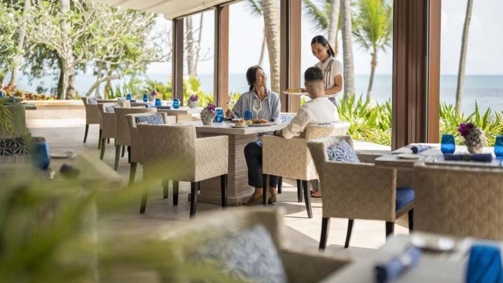  Beachfront dining at Four Seasons Resort Koh Samui, featuring stunning ocean views and a luxurious atmosphere.