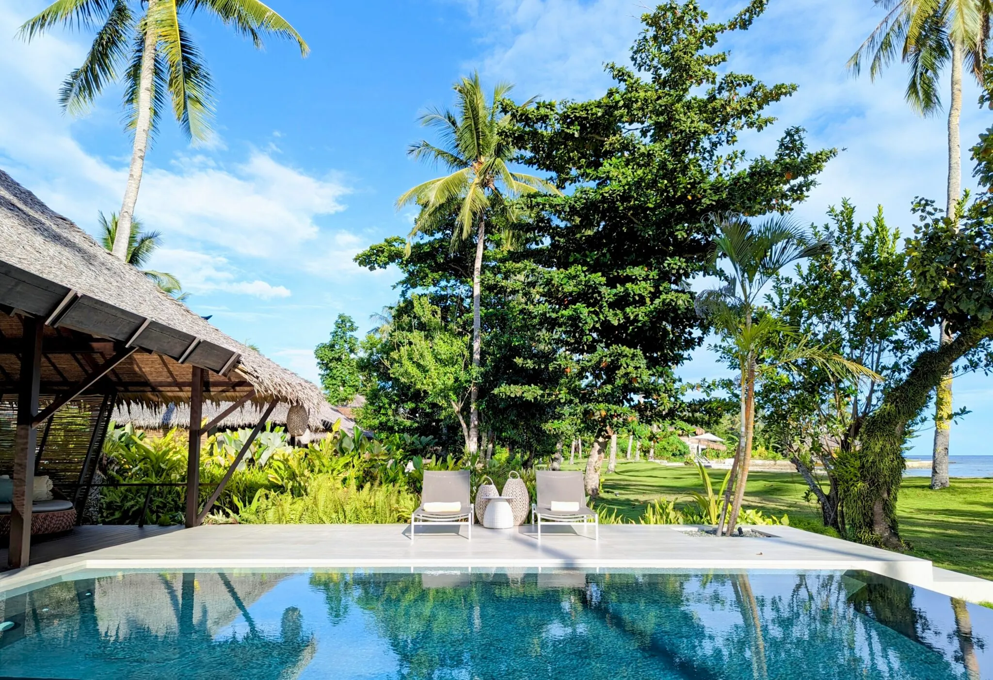 Private infinity pool and sun loungers at Kalinaw Resort, a boutique villa resort in Siargao, Philippines.