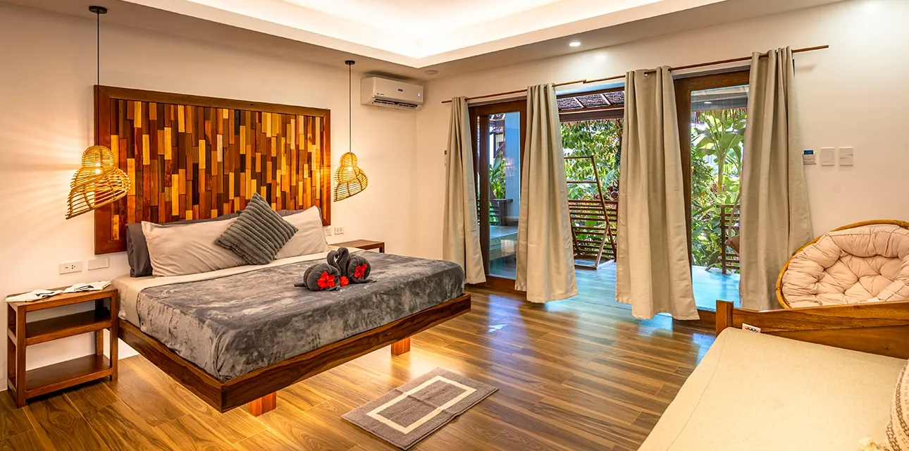 Bedroom interior at Siargao Island Villas, a Balinese-style oceanfront villa resort in General Luna, Siargao.