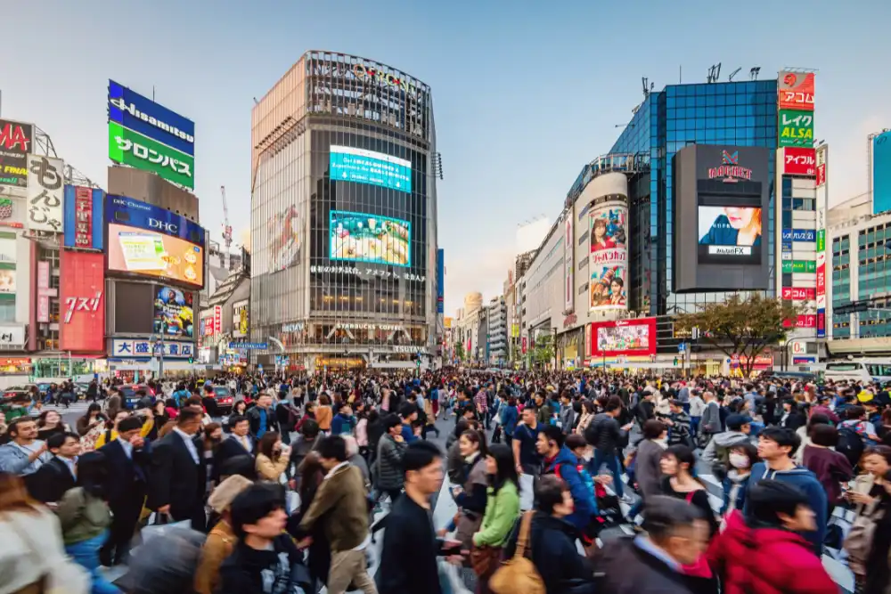 The vibrant energy of Shibuya Crossing in Tokyo at dusk, illustrating the urban luxury travel experiences and logistics managed by a professional Japan DMC.