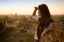 Traveller watching sunrise over the temples of Bagan, Myanmar