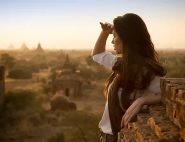 Traveller watching sunrise over the temples of Bagan, Myanmar