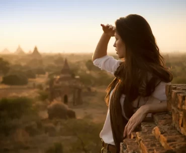 Traveller watching sunrise over the temples of Bagan, Myanmar