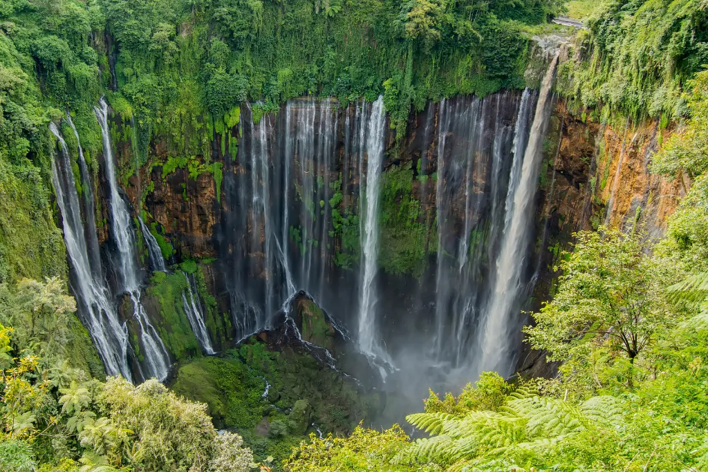 Discover the stunning 'Thousand Waterfalls' of Tumpak Sewu, Indonesia, an exclusive natural wonder for luxury travelers and adventurous MICE programs.