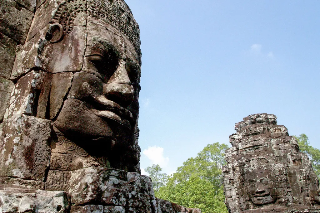 Majestic stone face tower at Bayon Temple in Angkor, symbolizing the depth of cultural exploration for discerning luxury clients.