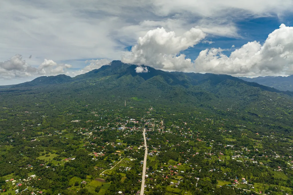 Breathtaking aerial view of Dumaguete's lush green landscape and majestic mountains, showcasing the region's natural beauty. Perfect for luxury travel itineraries, scenic tours, and a stunning backdrop for MICE events in the Philippines.