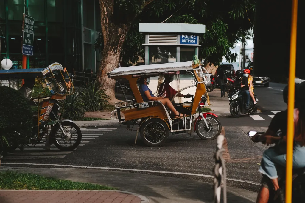 Experience the vibrant local life of Dumaguete City, Philippines, with its iconic tricycles. Ideal for authentic cultural immersion and efficient ground transport for luxury travel groups or MICE delegates exploring the city.