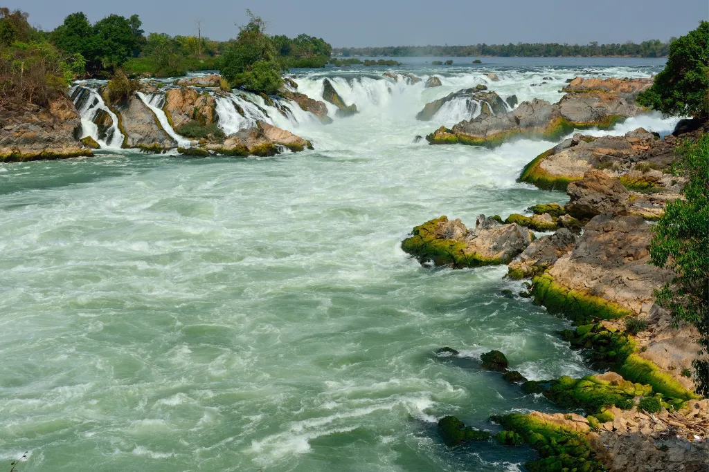 Powerful Khone Phapheng Waterfall in Laos, showcasing dramatic natural landscapes for luxury adventure tours and unique team-building activities managed by our DMC.