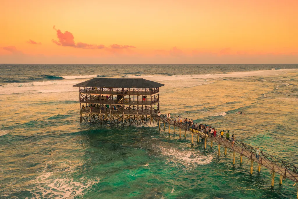 Iconic Cloud 9 surf break pier and viewing deck at sunset in Siargao, a premier luxury experience and unique venue for MICE events in the Philippines.