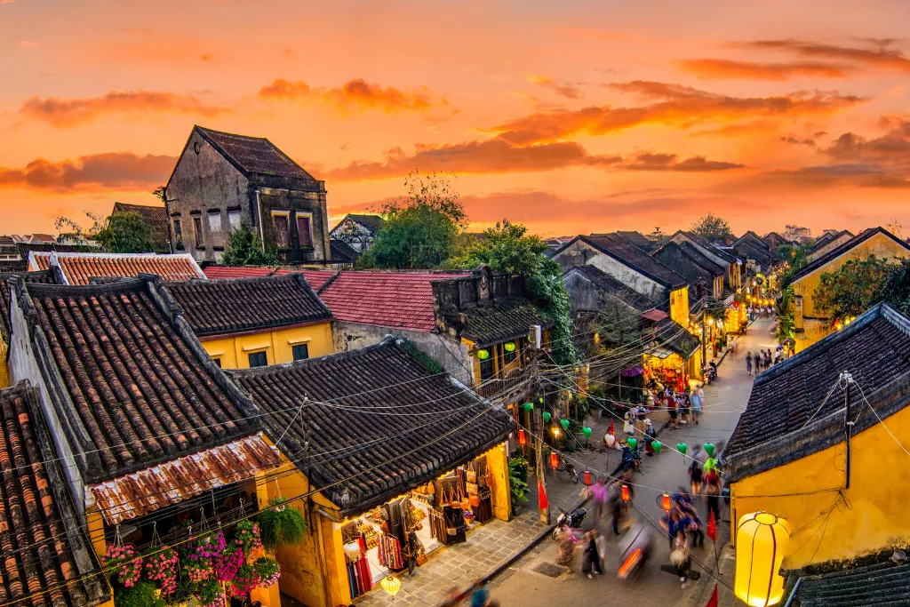 Panoramic sunset view over the historic rooftops of Hoi An Ancient Town, Vietnam, showcasing the charm and beauty that a luxury DMC can provide for discerning travelers and MICE groups.