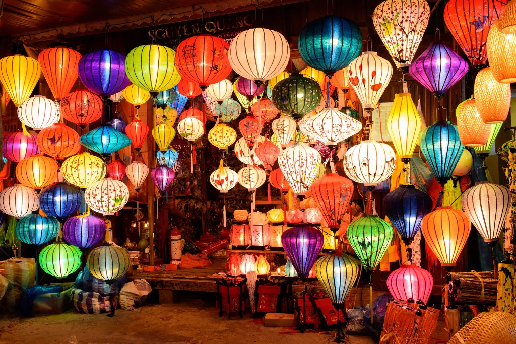 Vibrant, handcrafted lanterns illuminate a bustling night market in Hoi An, Vietnam, perfect for a luxury MICE group event or incentive travel experience.