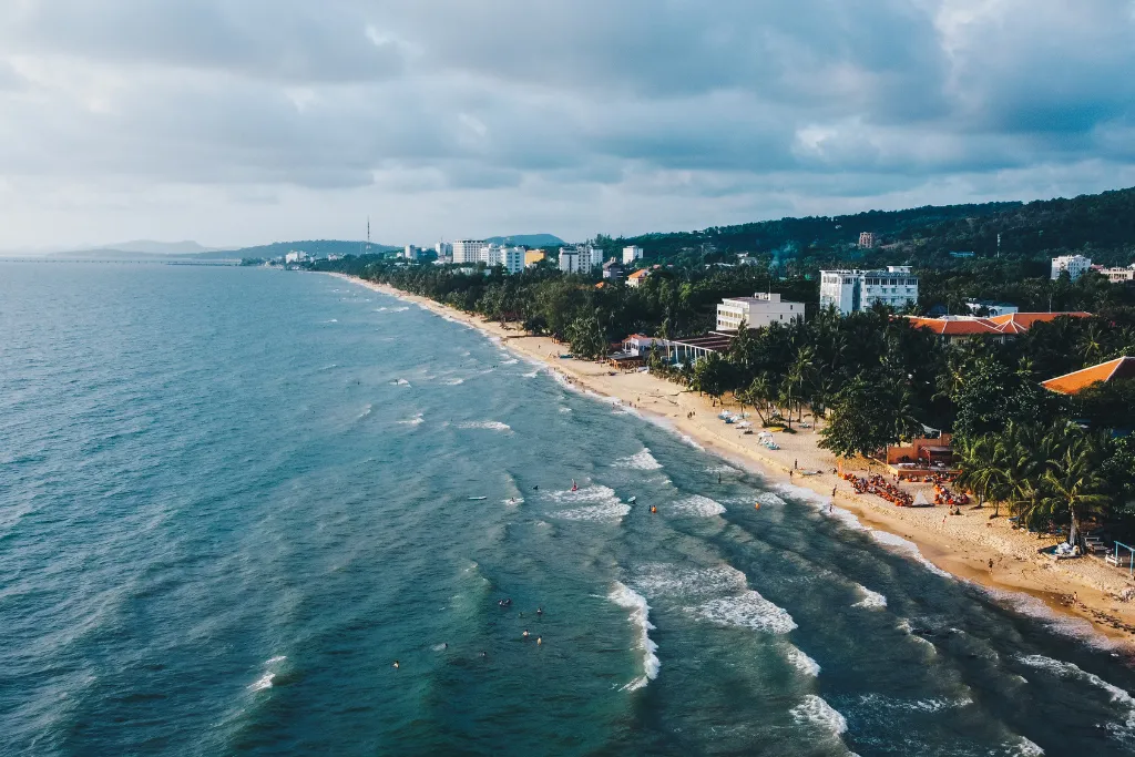 Expansive long beach in Phu Quoc lined with luxury resorts and a vibrant atmosphere, perfect for upscale leisure travelers and corporate retreats.